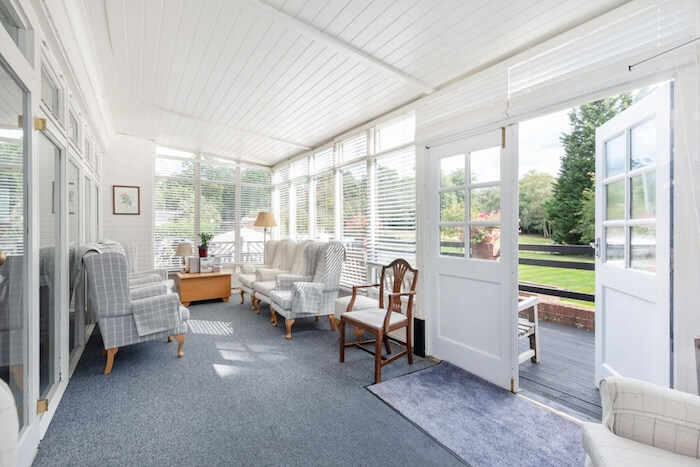 Bright and airy living space with plenty of chairs.