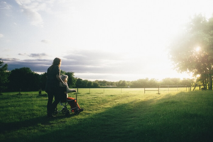 Two people on an afternoon stroll in a field.